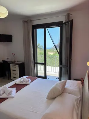 a bedroom with a bed and a large window at B&B La Chiocciola in Castelluzzo