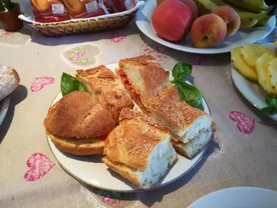 a plate of food with bread and apples on a table at B&B La Chiocciola in Castelluzzo