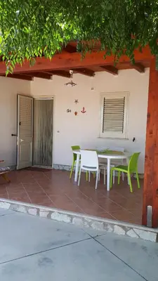 a patio with a table and chairs on it at Casa Vacanza Demi in Alcamo Marina