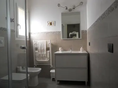 a bathroom with a sink and a toilet and a mirror at Tenuta Sperlinga - Il Campanile in Santa Flavia