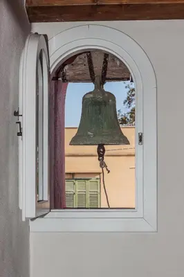an open window with a bell hanging from it at Tenuta Sperlinga - Il Campanile in Santa Flavia