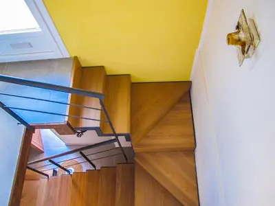 a staircase with a glass railing and wood floors at Tenuta Sperlinga - Il Campanile in Santa Flavia