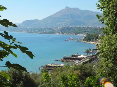 a view of a body of water with a mountain at Tenuta Sperlinga - Il Campanile in Santa Flavia