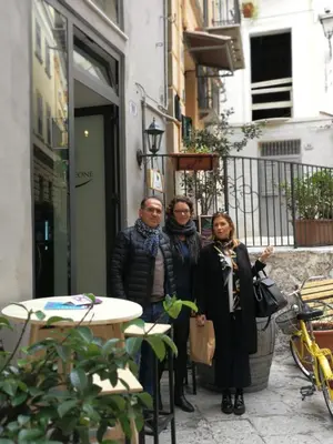 a group of three people standing outside of a building at Appartamento san Domenico in Palermo