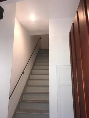 a stairway with a white wall and a white door at Appartamento san Domenico in Palermo