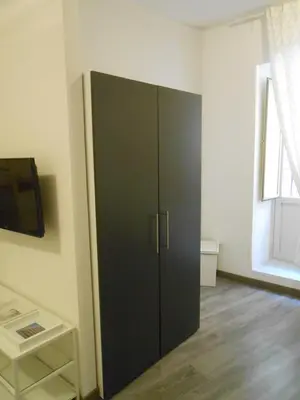 a black cabinet in a room with a window at Appartamento san Domenico in Palermo