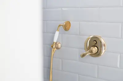 a shower with a shower head on a white tiled wall at Settegrana in Cinisi