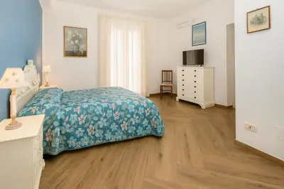 a bedroom with a bed and a dresser at Matilde Boutique Hotel by AR Group Hotels in Isola delle Femmine