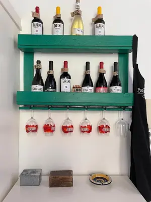 a display of wine bottles on a shelf at 3Sisters Apartments in Palermo