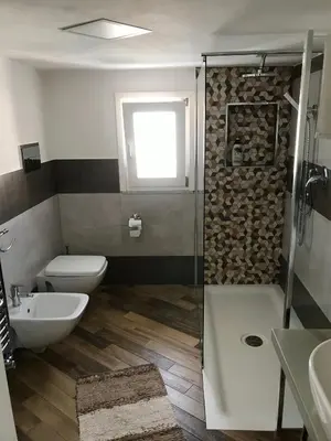 a bathroom with a shower and a toilet and a sink at Ballarò Holiday in Palermo