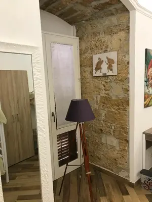 a room with a brick wall and a lamp at Ballarò Holiday in Palermo