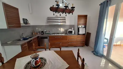 a kitchen with a table and a dining room at Villa Margherita in Terrasini