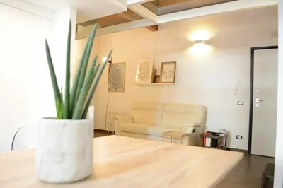 a living room with a couch and a table with a plant at Uloft Apartment Palermo in Palermo