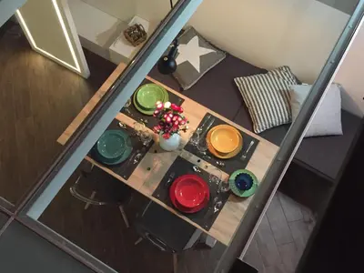 a table with many different colored paints on it at Uloft Apartment Palermo in Palermo