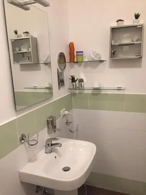 a bathroom with a sink and a mirror at Uloft Apartment Palermo in Palermo