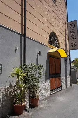 a building with potted plants in front of a door at Uloft Apartment Palermo in Palermo
