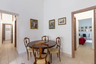 a dining room with a table and chairs at Sant'Agostino Apartment by DomuSicily in Palermo