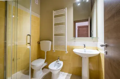 a bathroom with a toilet and a sink at Sant'Agostino Apartment by DomuSicily in Palermo