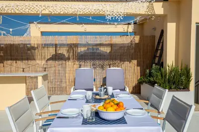 a table with a bowl of oranges on it at Casa Colibrì - Solemar Sicilia in Santa Flavia