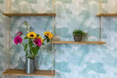 a vase of flowers on a shelf in a room at Casa Colibrì - Solemar Sicilia in Santa Flavia