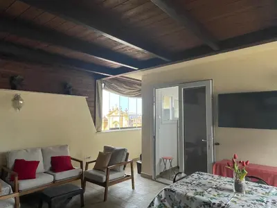 a room with a table and chairs and a window at Suite de la Sicilienne in Castellammare del Golfo