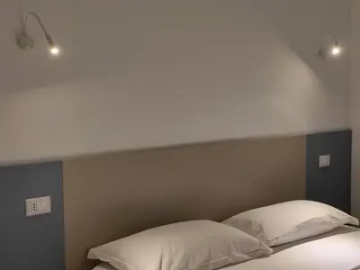 a bed with two white pillows on top of it at B&B Vista Mare in San Vito lo Capo