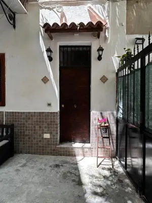 a brown door on the side of a house at Al Cortiletto in Palermo