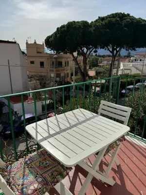 a white bench sitting on top of a balcony at Holiday mondello in Mondello