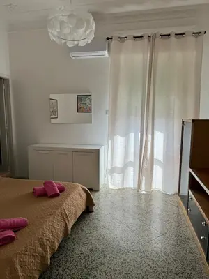a bedroom with a bed with two pink pillows on it at Holiday mondello in Mondello