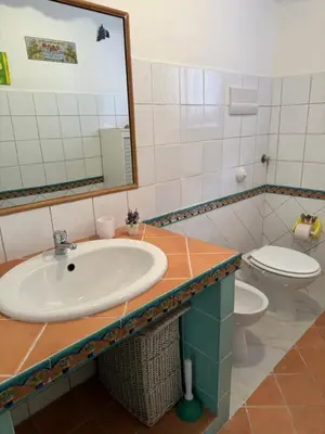 a bathroom with a sink and a toilet at Holiday mondello in Mondello