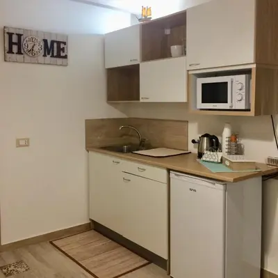 a small kitchen with a sink and a microwave at Ca&Sa Sweet Holiday in Cinisi