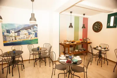 a restaurant with tables and chairs and a painting on the wall at B&B Nencioli in Castellammare del Golfo