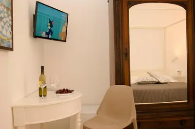 a room with a mirror and a table and a chair at B&B Nencioli in Castellammare del Golfo