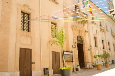 a kite is flying in front of a building at B&B Nencioli in Castellammare del Golfo