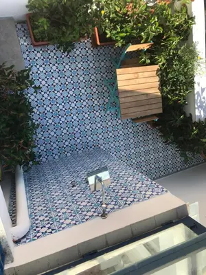 a bathroom with a blue tile floor with a sink at Charming loft con Terrazze al Teatro Massimo in Palermo