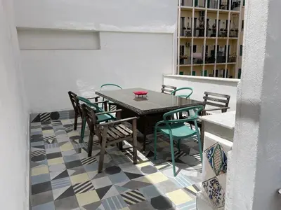 a dining room with a table and chairs on a checkered floor at Charming loft con Terrazze al Teatro Massimo in Palermo