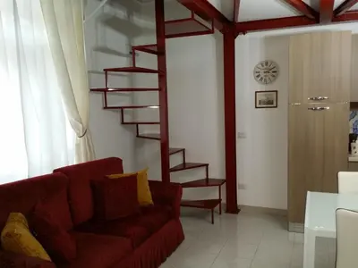 a bedroom with four pictures on the wall at La casetta di Tilde in Termini Imerese