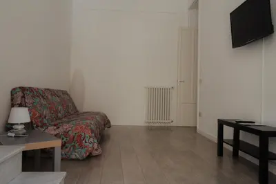 a living room with a couch and a tv at Dietro al Massimo in Palermo