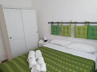 a bedroom with a large bed with towels on it at Villa Limone in Castellammare del Golfo