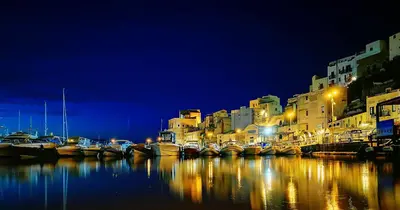 a group of boats docked in a harbor at night at Villa Limone in Castellammare del Golfo