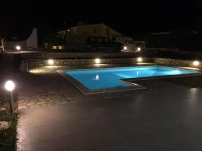 a swimming pool at night with lights at Villa Limone in Castellammare del Golfo