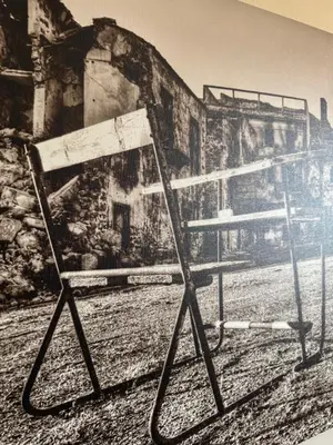 a chair in front of a wall with a painting at Palace Bed & Breakfast in Salaparuta