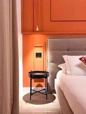 a bedroom with a table next to a bed at Villa di Nera B&B in Palermo