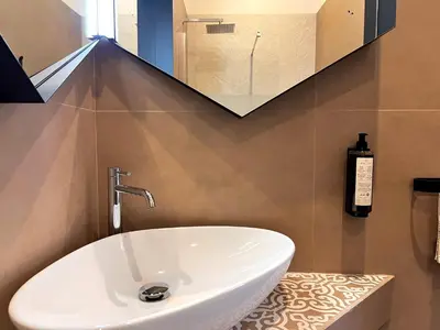 a bathroom with a white sink and a mirror at Villa di Nera B&B in Palermo