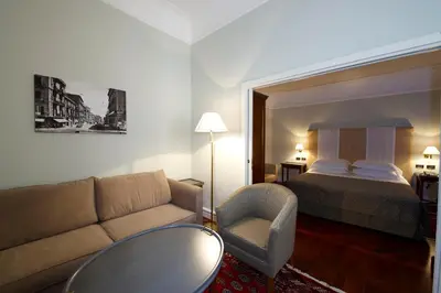 a hotel room with a couch and a bed at Grand Hotel Piazza Borsa in Palermo