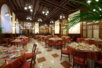 a large banquet hall with tables and chairs with plates and dishes at Grand Hotel Piazza Borsa in Palermo