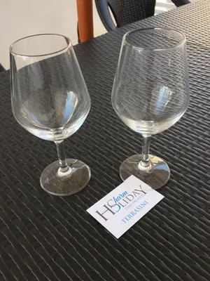two wine glasses sitting on top of a table at Charm Holiday in Terrasini