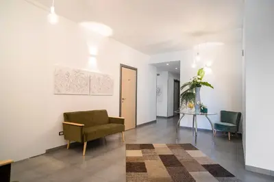 a living room with a chair and a table at Enny Camere in Alcamo
