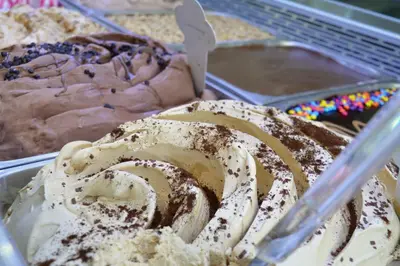 a chocolate bundt cake with whipped cream in a container at Enny Camere in Alcamo