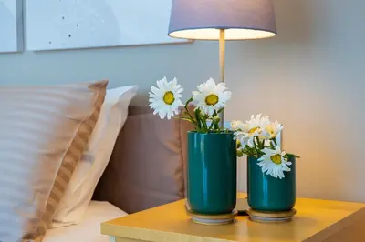 two blue vases with white flowers on a table at Enny Camere in Alcamo